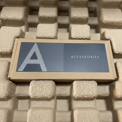 Box labeled 'Accessories' on a textured stone surface