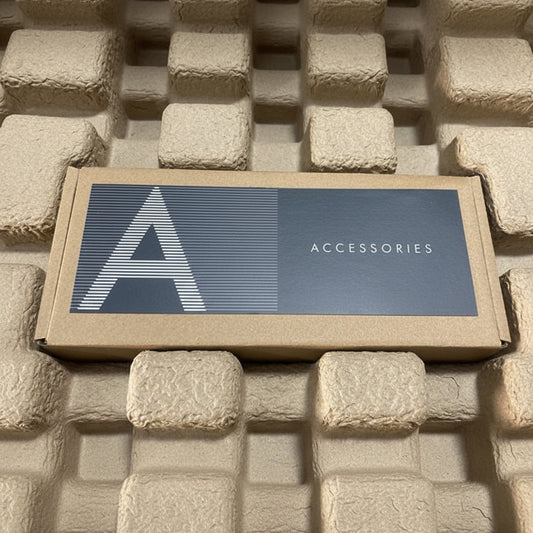 Box labeled 'Accessories' on a textured stone surface
