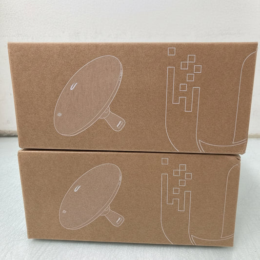 Two cardboard boxes with white line drawings of a dish and geometric shapes on a light background